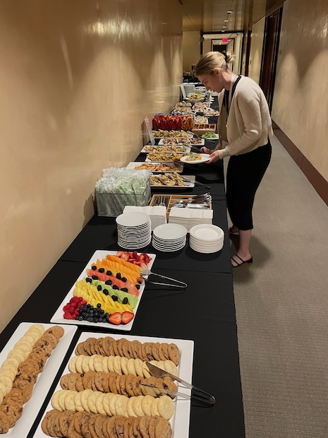 Conference emcee Kay Sorin building a lunch plate for front desk at Luxury Roundtable's Luxury Women Leaders Summit New York June 13